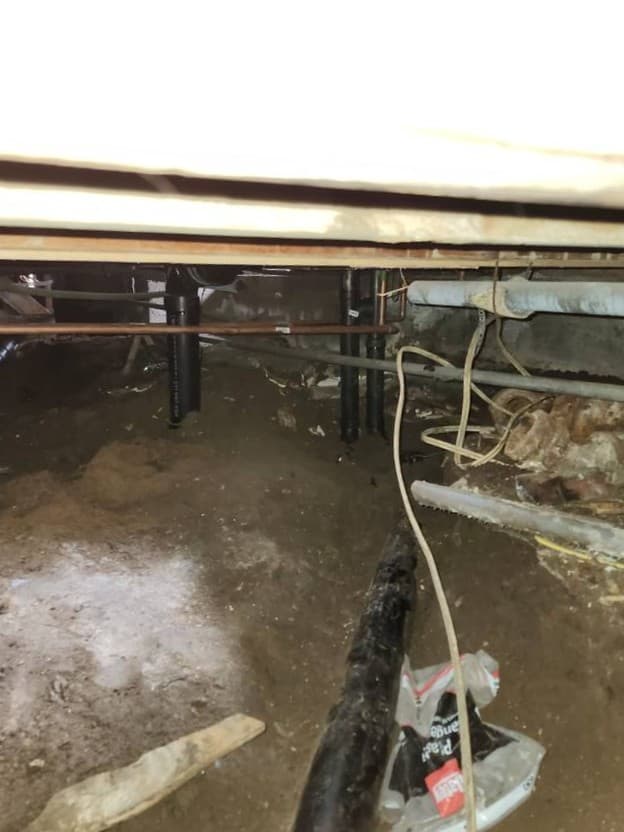 Severe plumbing leak under flooring with standing water and damaged subfloor